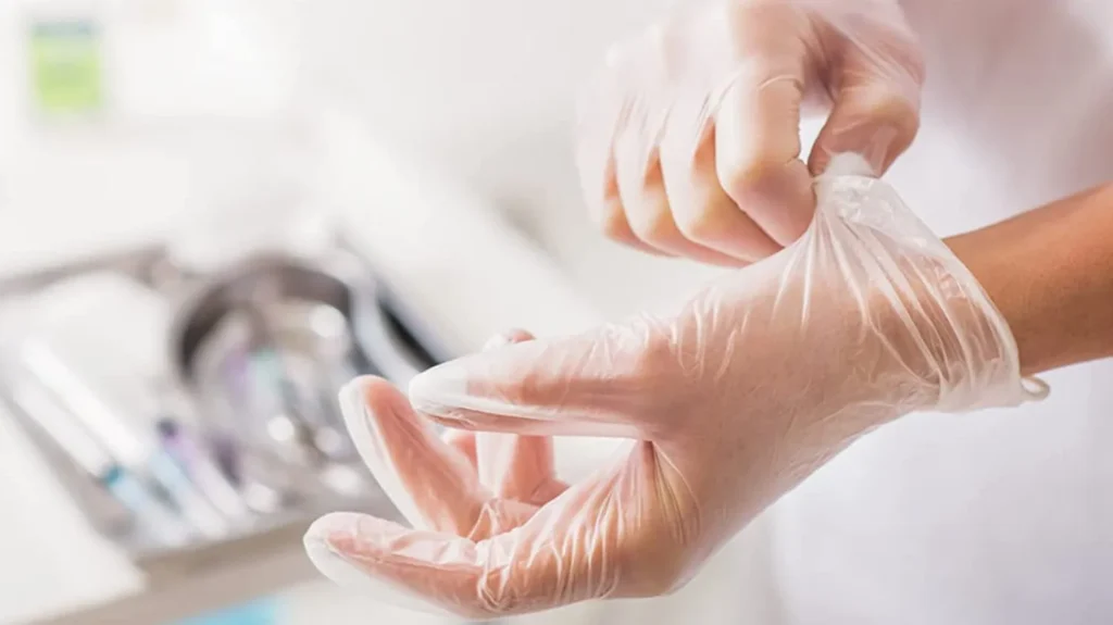 Person wearing disposable gloves for hygiene